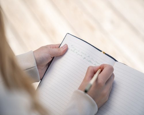 writing notes in a personal journal for self-observation